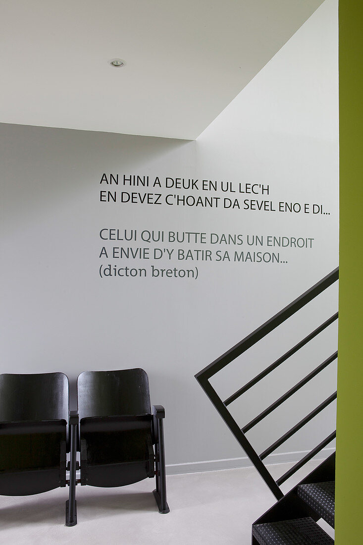 Quote on wall above vintage cinema seats in foyer with epoxy resin floor
