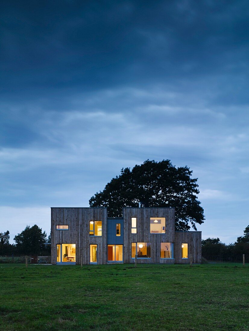 Modern architect-designed house with illuminated windows