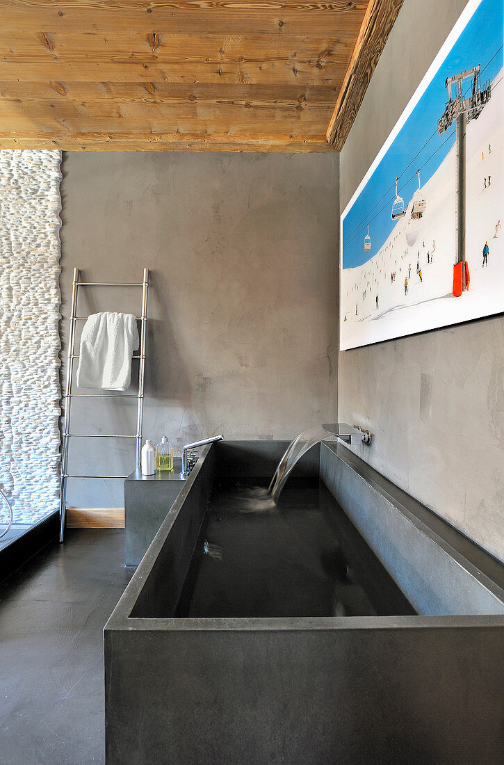 Square stone trough used as sink in modern bathroom