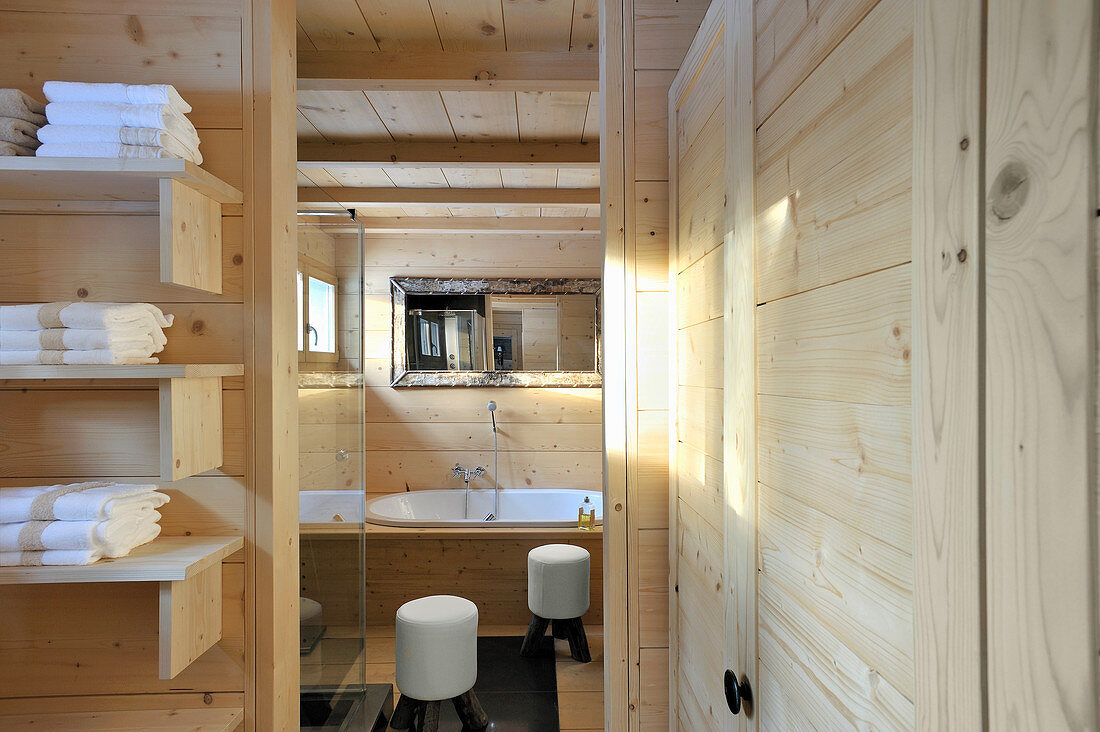 Bathroom with wood-clad walls and ceiling