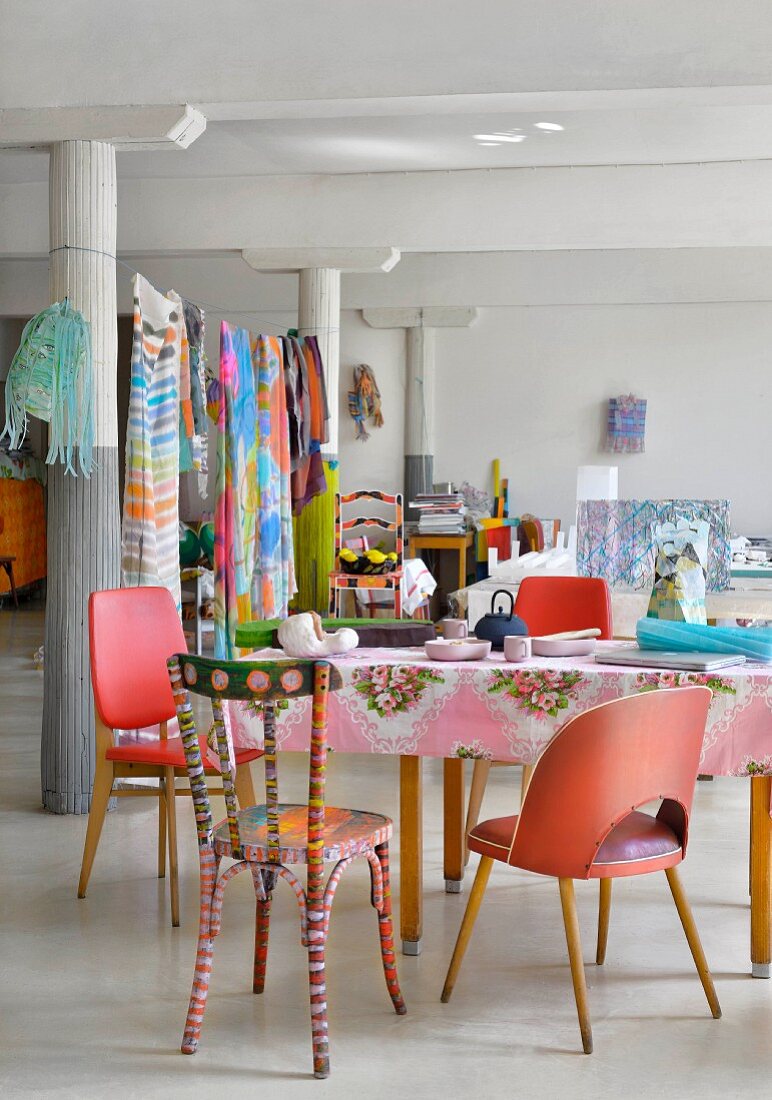 Columns and colourful eclectic furnishing in loft apartment