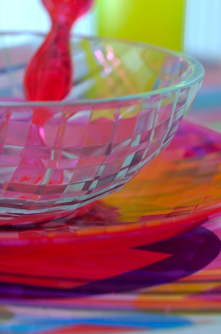 Red fork on glass bowl on colourful place mat