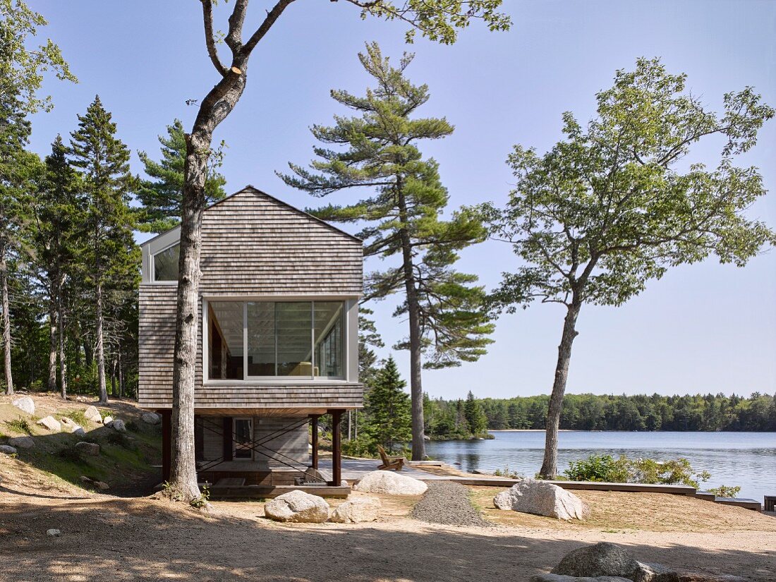 Modern, architect-designed house on stilts next to lake