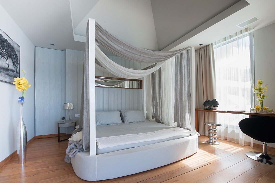 Four-poster bed in sophisticated bedroom in shades of grey
