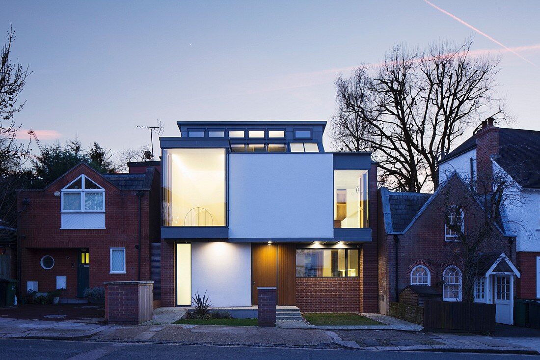 Modern architect-designed house between traditional houses