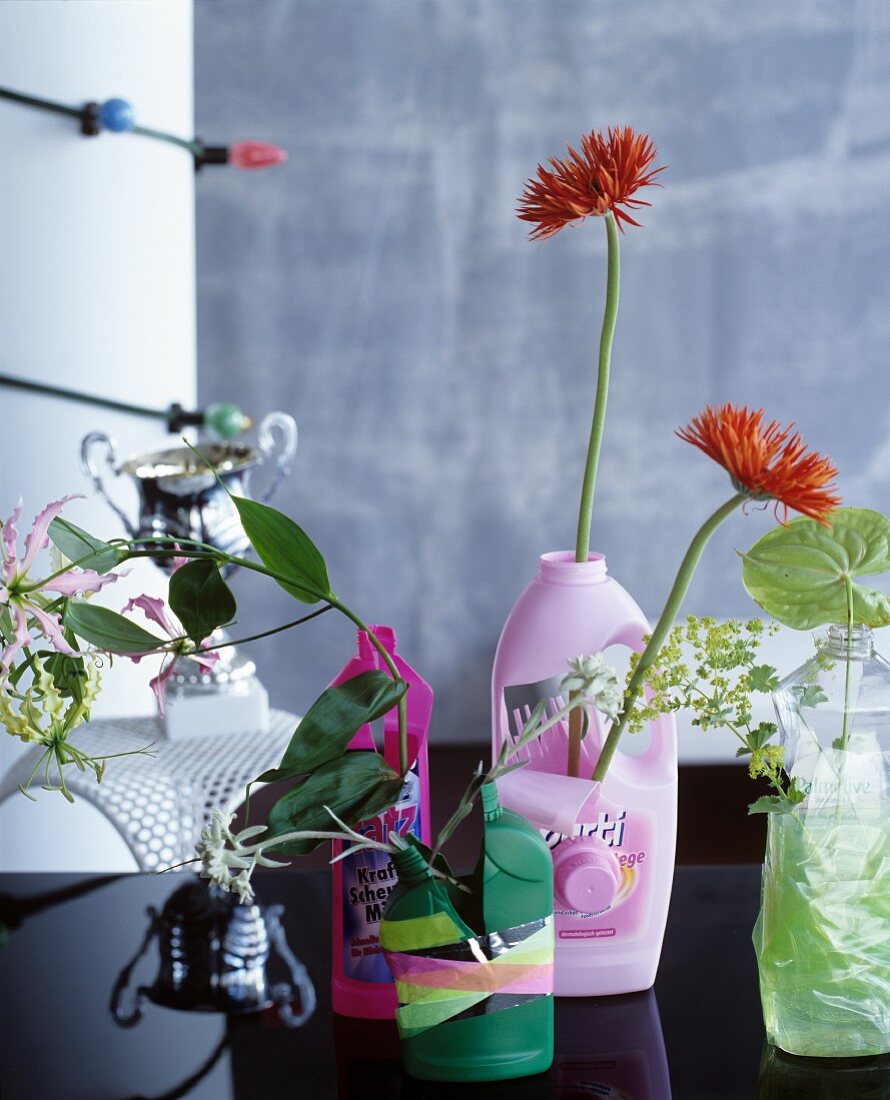 Old cleaning agent bottles used as vases