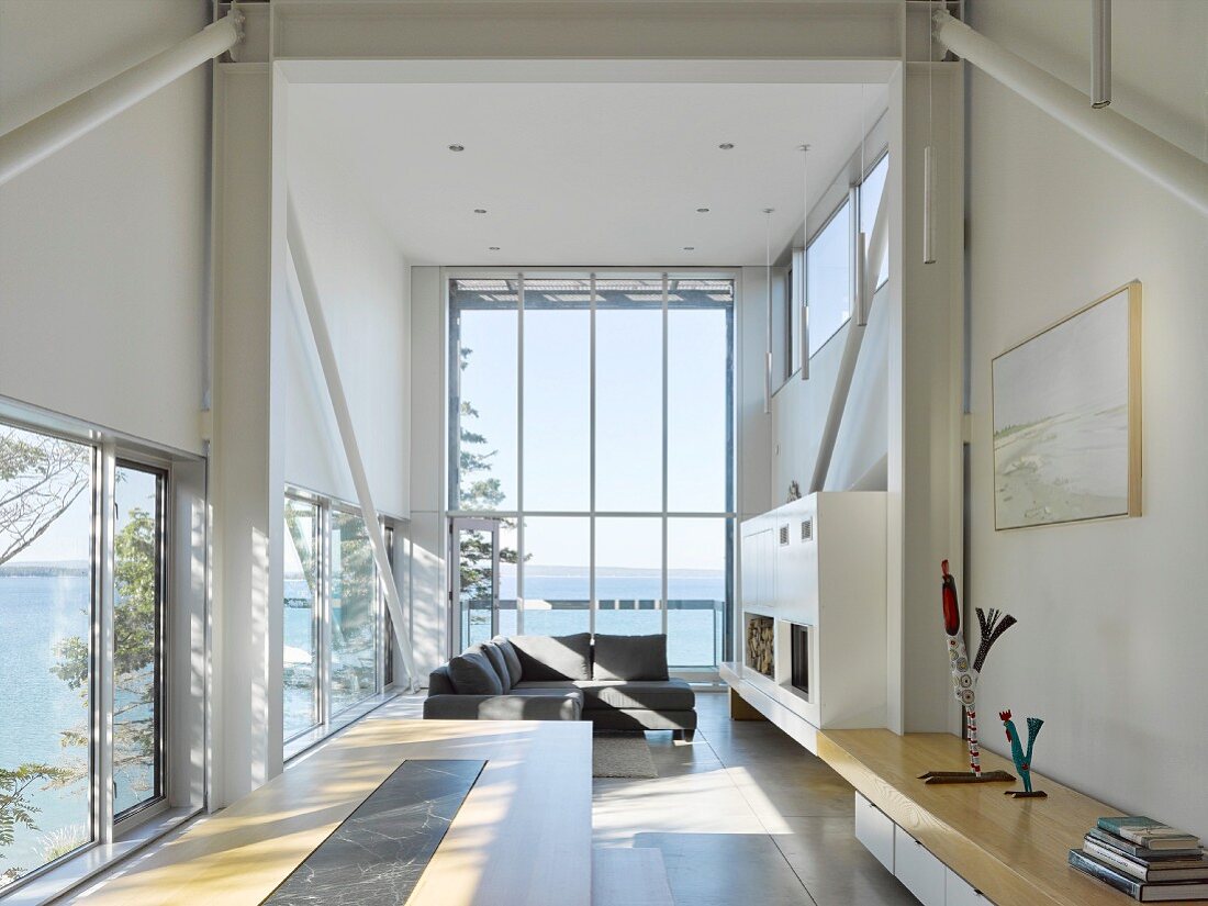 Living area in experimental beach-house with panoramic window and sea view