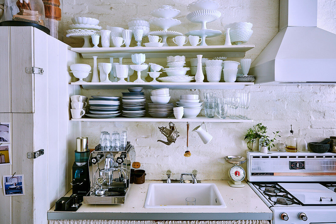 Fully loaded crockery shelf over sink in vintage kitchen