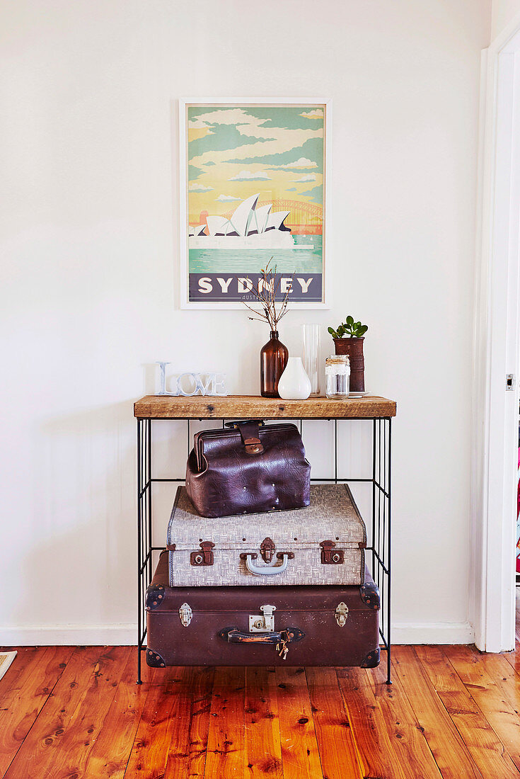 Vintage shelf with suitcases, above with picture with 'Sydney' motif