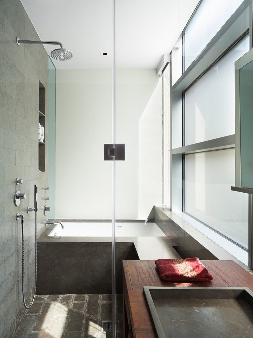 Shower and fitted bathtub in modern bathroom