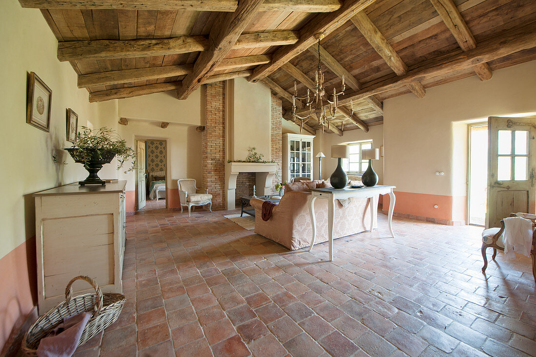 Terracotta floor and exposed roof structure in Mediterranean living room