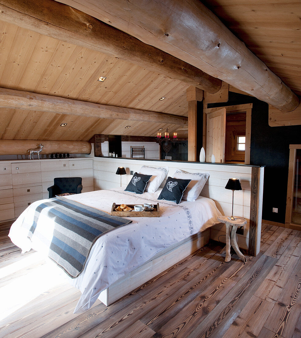 Bed with partition headboard in attic bedroom