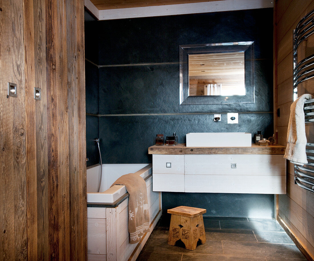 Modern bathroom furnishings and wood panelling in rustic bathroom