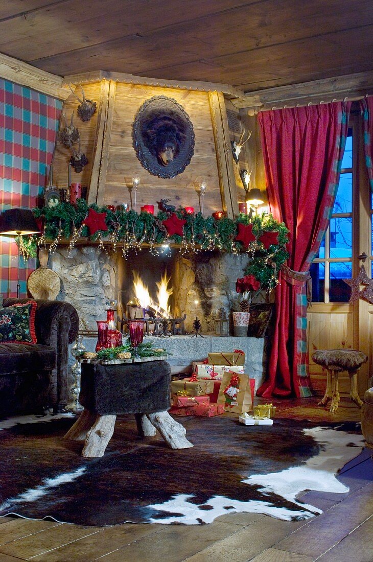 Weihnachtlich dekorierter Kamin im gemütlichen Chalet-Wohnzimmer