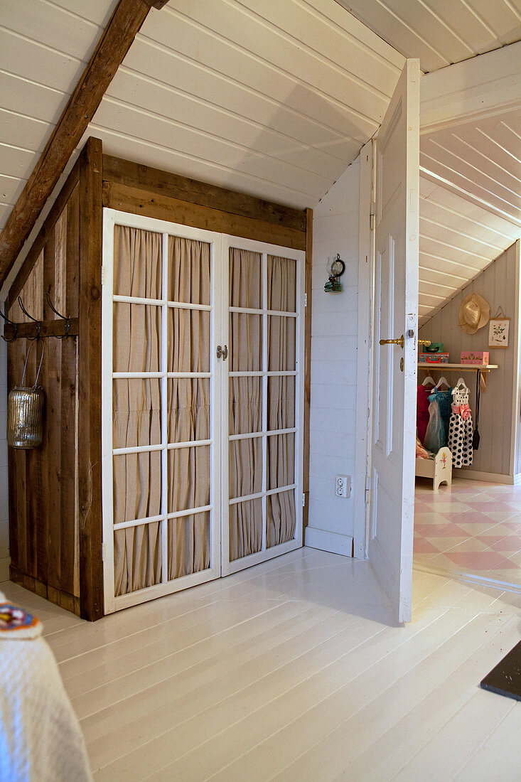 Wardrobe with lattice doors and curtains fitted in knee wall