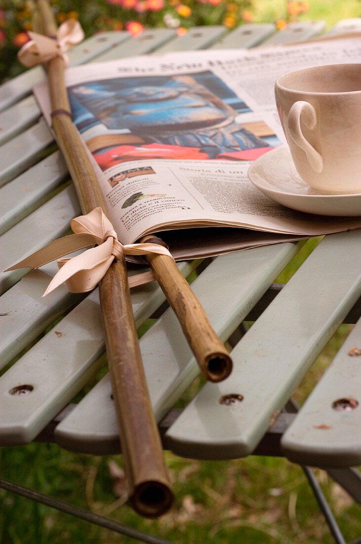 Zeitungshalter aus Bambusrohr mit Zeitung und eine Tasse