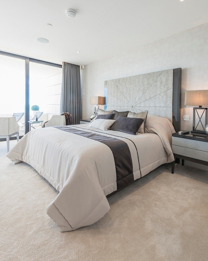 Elegant bedroom in shades of beige with glass wall