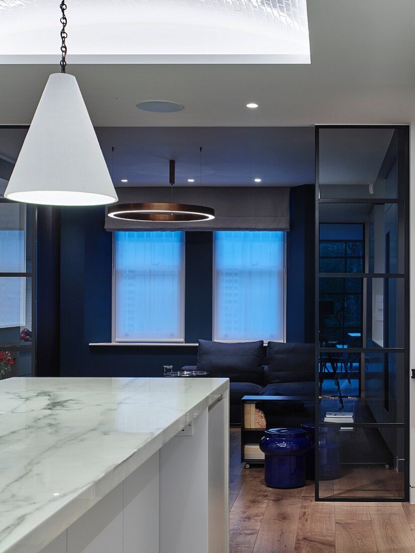 Marble kitchen island and living room in shades of blue and black