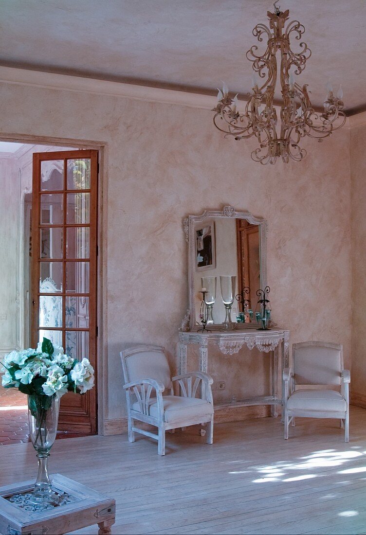 French-style interior with lime-washed walls and chandelier
