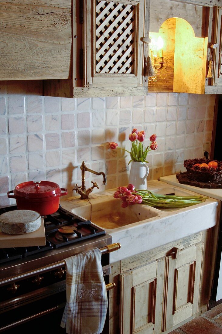 Tulips in sink of rustic country-house kitchen