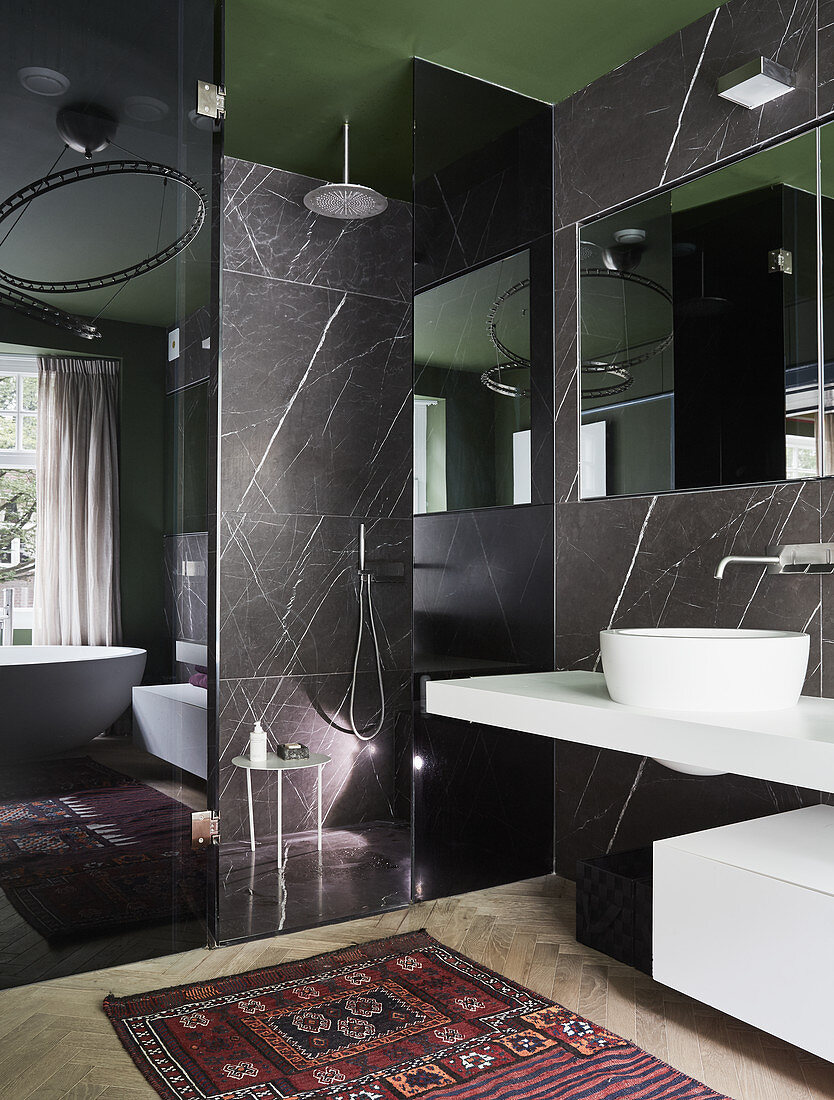 Marble walls and walk-in shower in modern bathroom