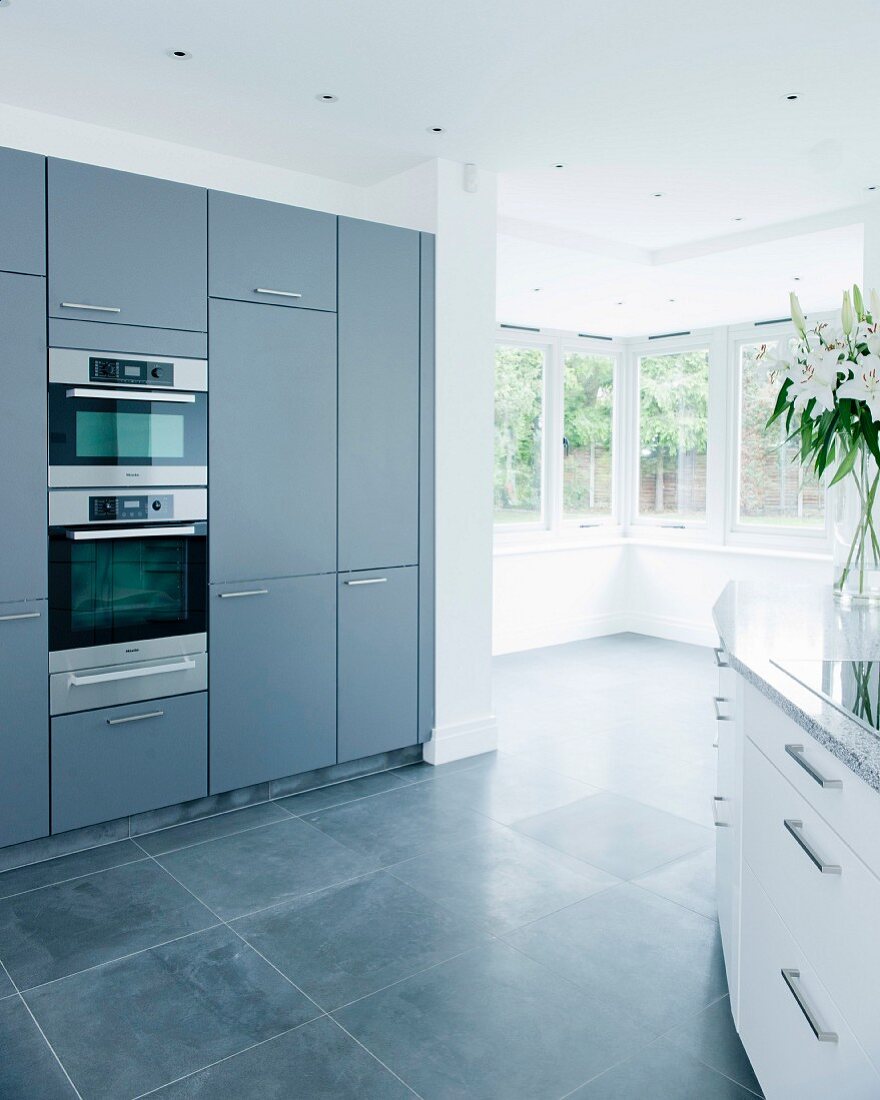 Grey fitted kitchen with corner windows