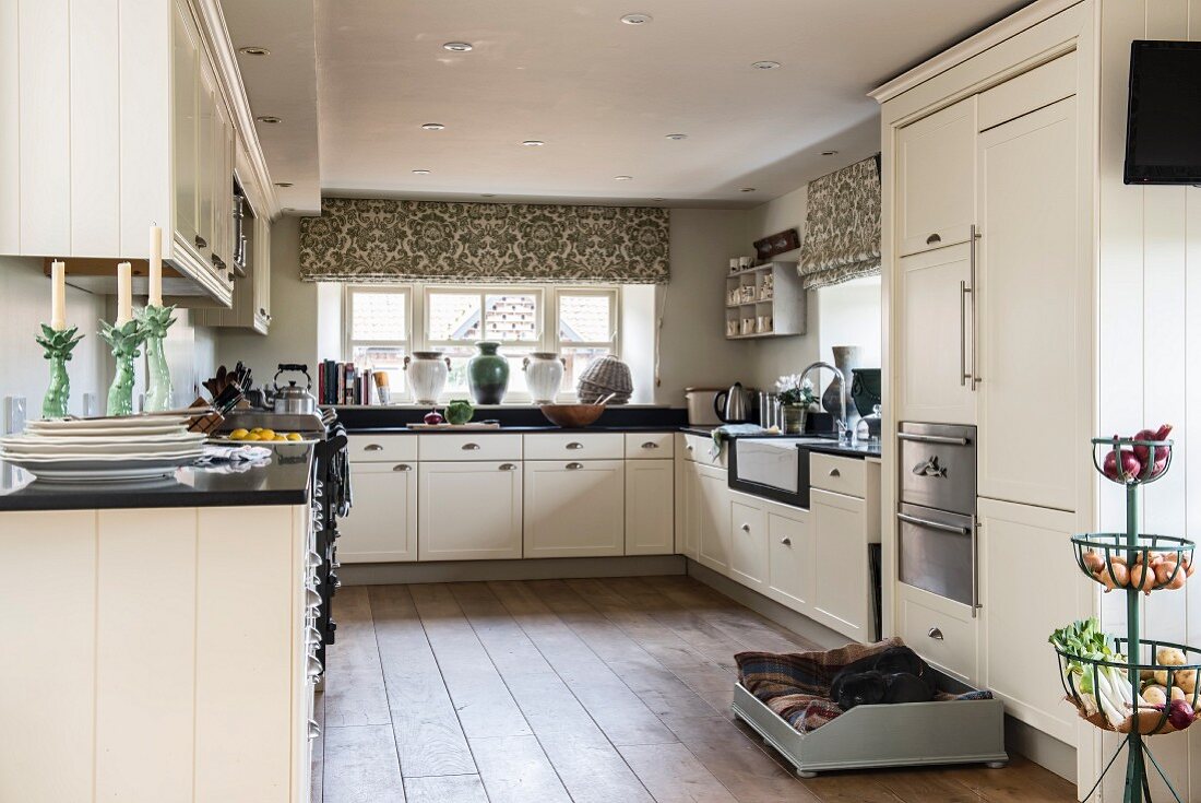 Large, white, modern, country-house kitchen with black worksurface