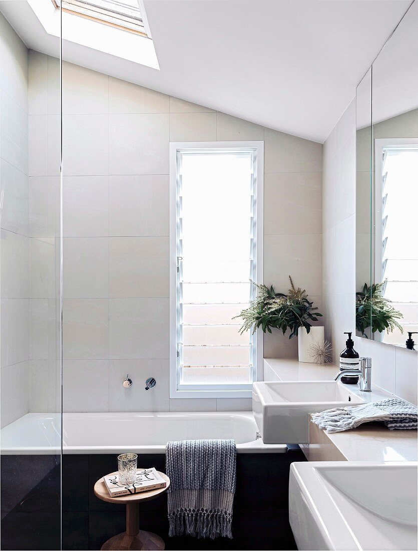 Small bathroom with bathtub under the sloping roof