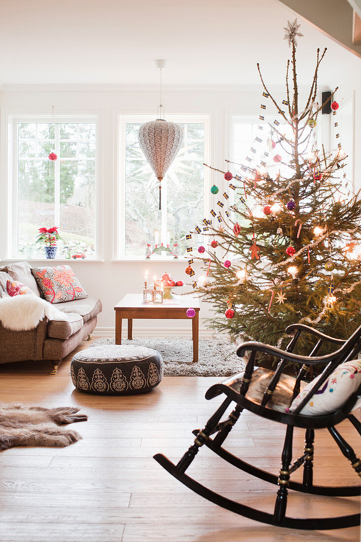 Rocking chair in front of decorated Christmas tree in living room