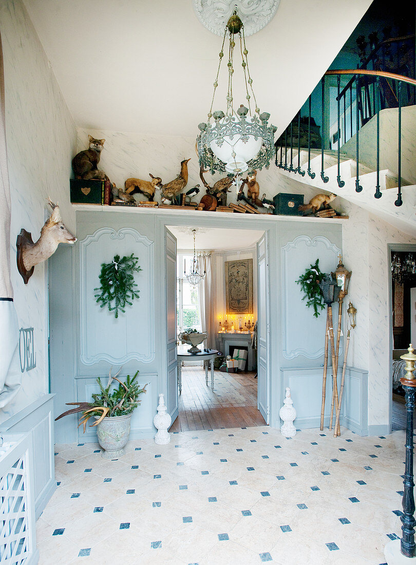 Panelled walls and hunting trophies in classic foyer