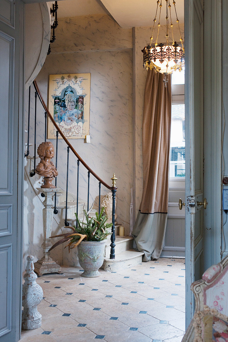 Foot of winding staircase in classic foyer