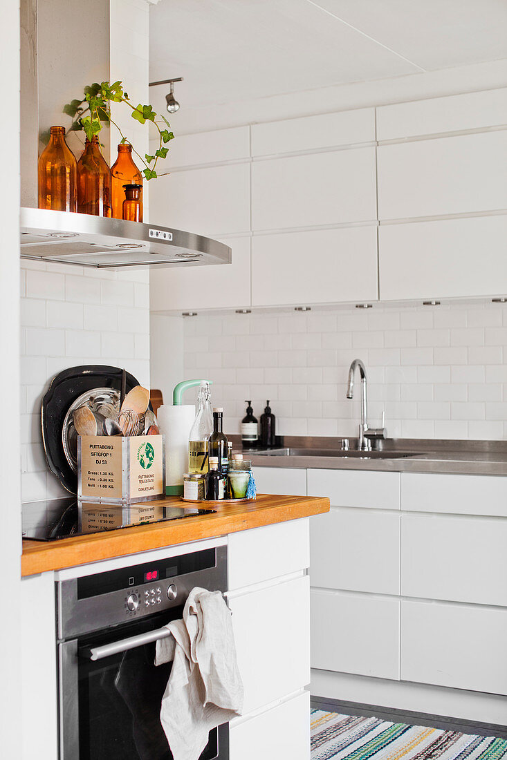 White fitted kitchen with subway wall tiles