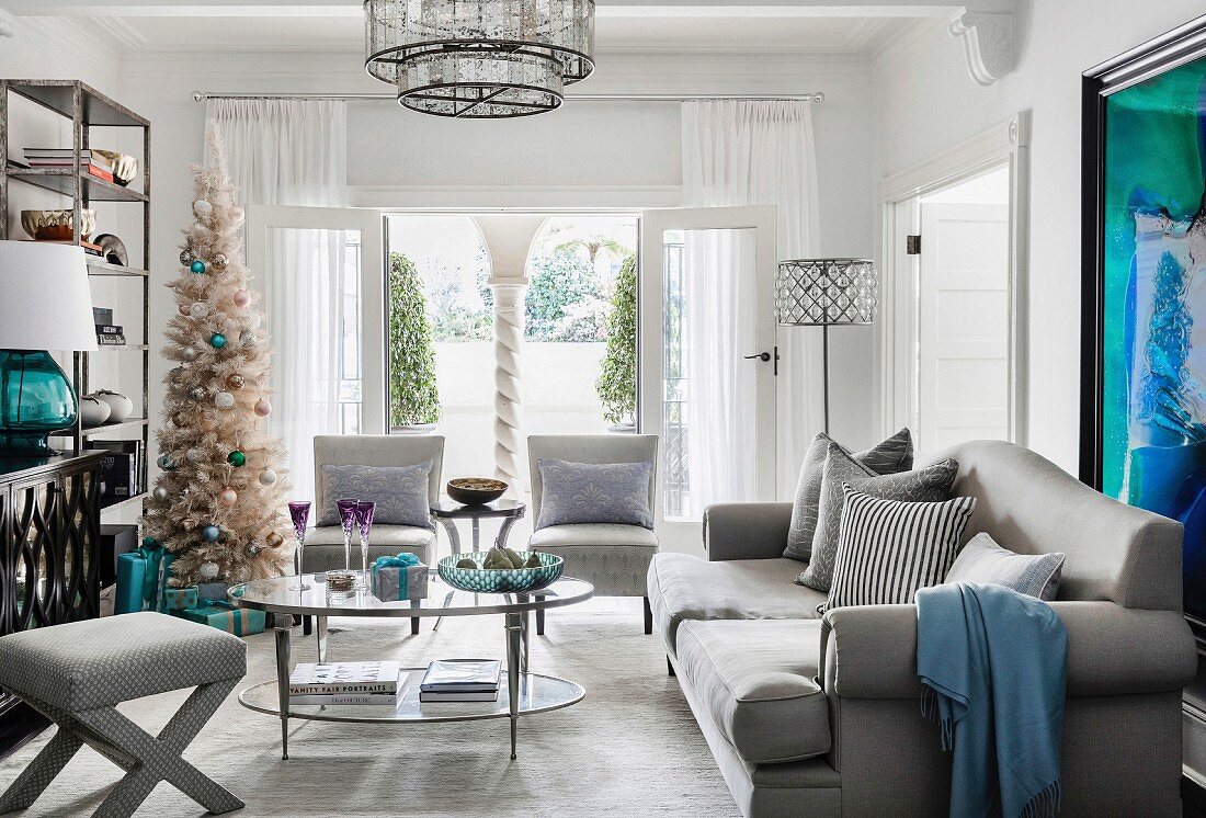 Glamorous living room in shades of gray with a Christmas tree