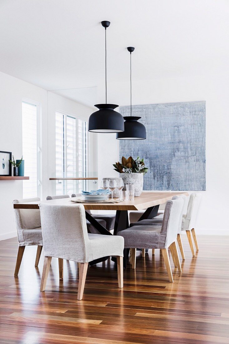 Modern dining room with upholstered chairs and wooden floors
