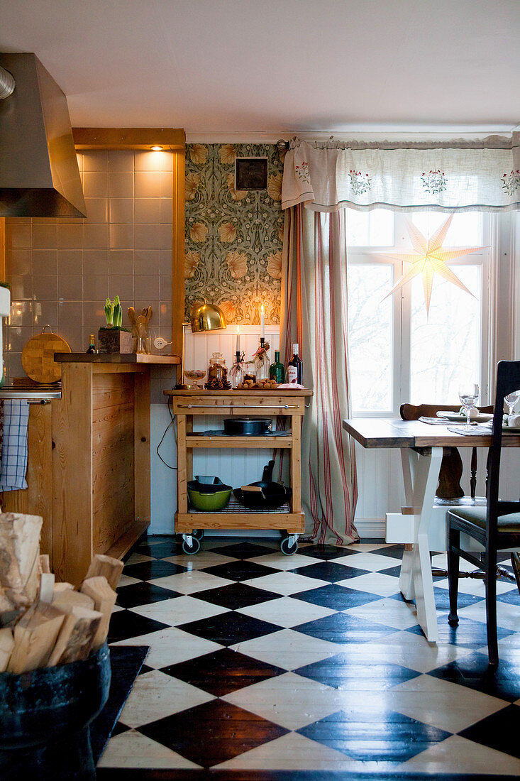 Serving trolley in cosy country-house kitchen with chequered floor