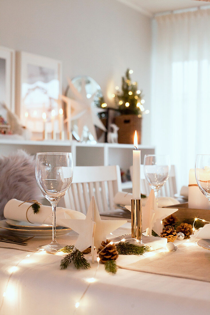 Festively decorated table set with white cloth and decorations
