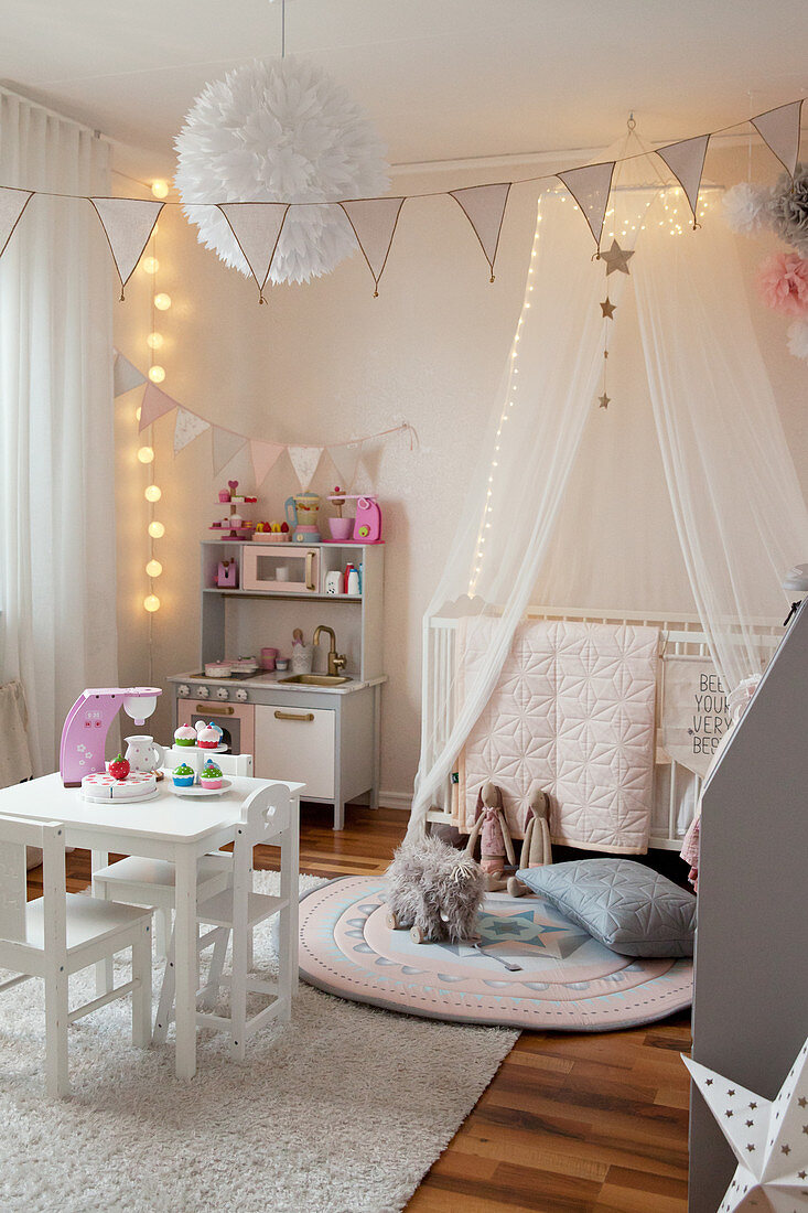 Play kitchen and child's table in child's bedroom with cosy lighting