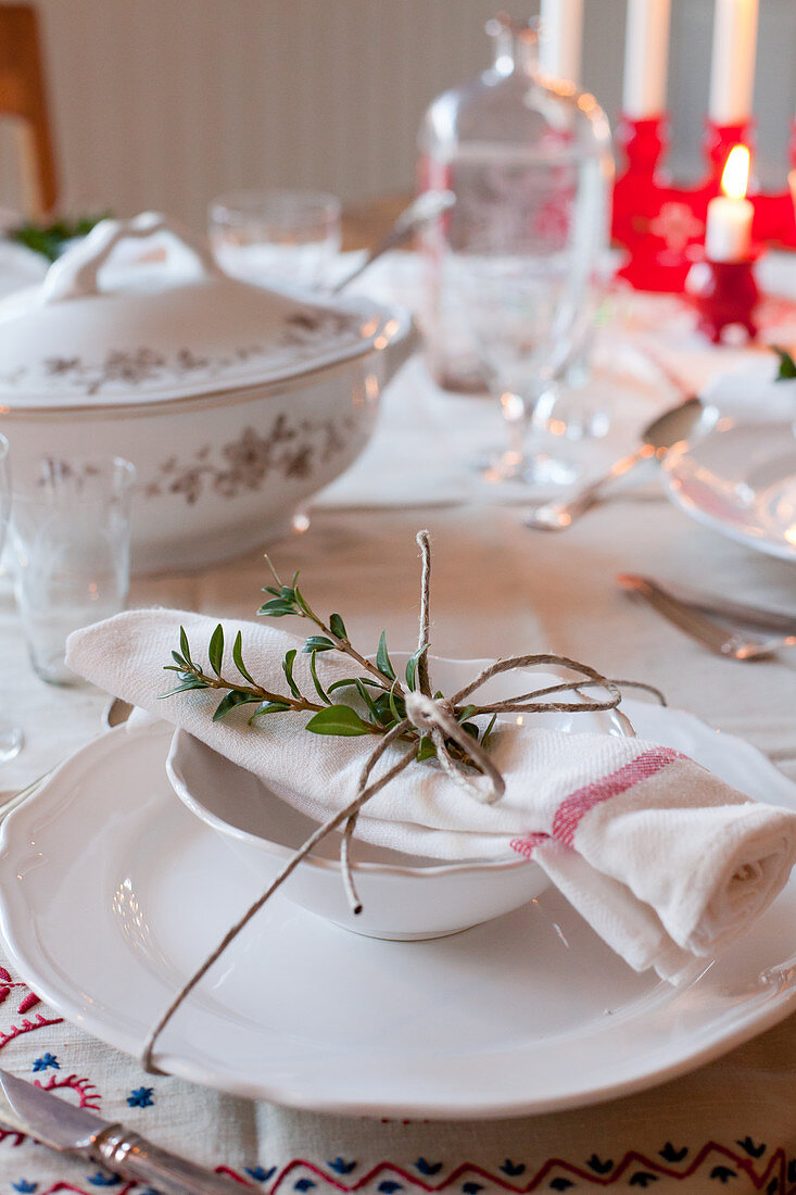 Napkin and twigs tied with string on set table
