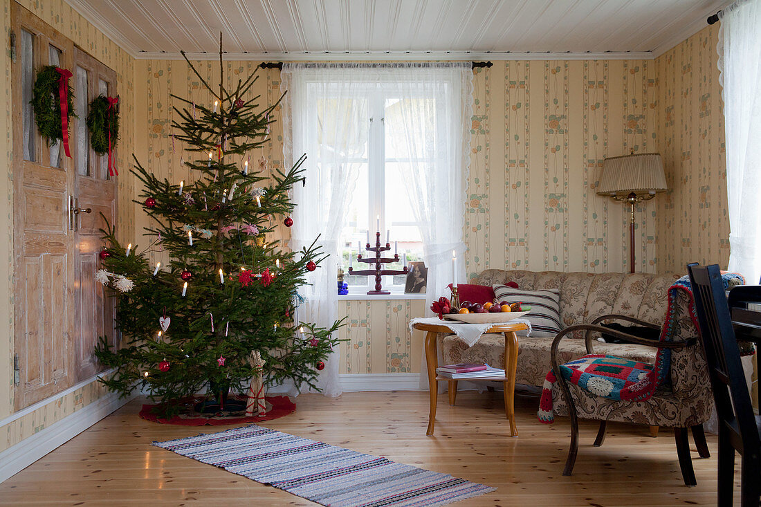 Christmas tree in living room with classic wallpaper