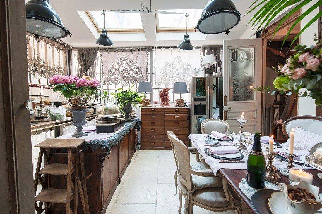 Festively set dining table in open-plan kitchen with vintage ambiance