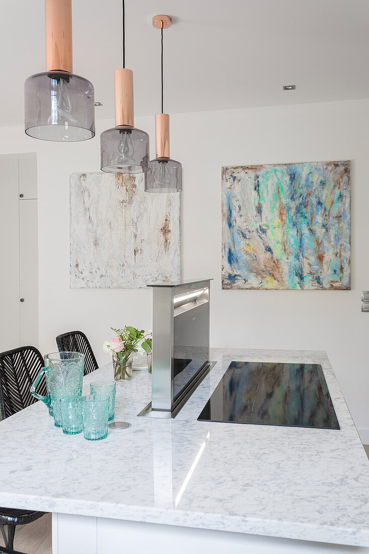 Lamps above island counter with marble worksurface
