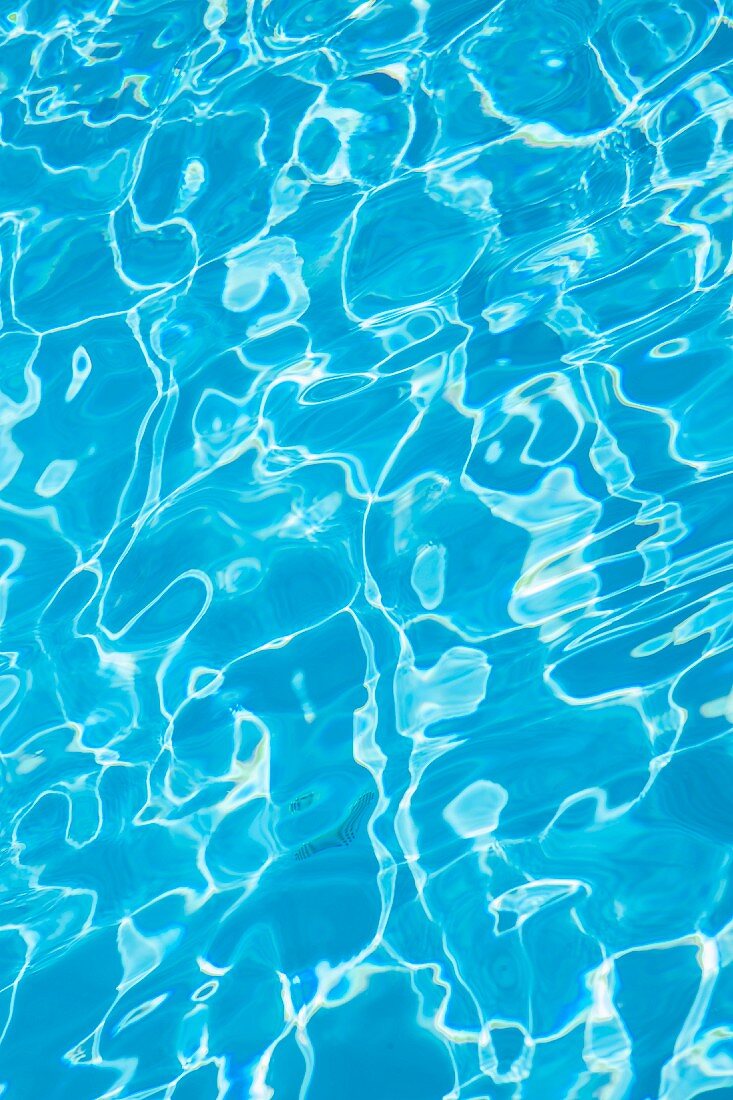Reflections on water in blue swimming pool