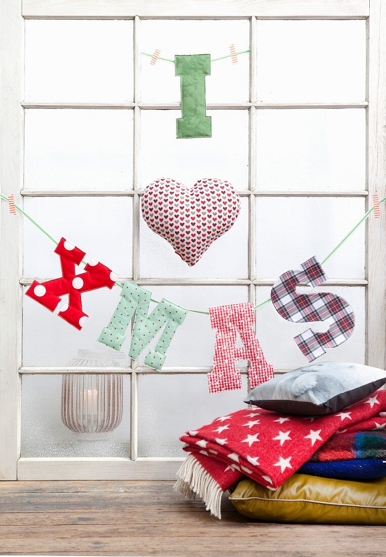 'I heart XMAS' made from fabric letters hung from lattice window