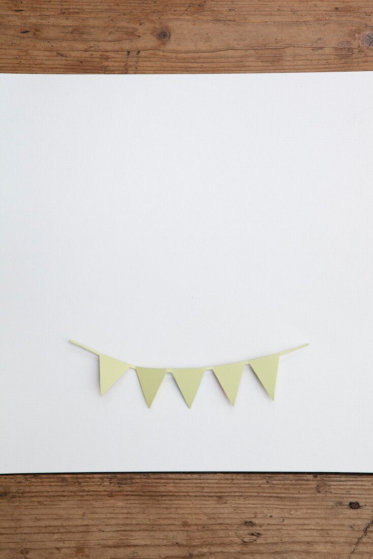 Bunting cut out of paper on white surface