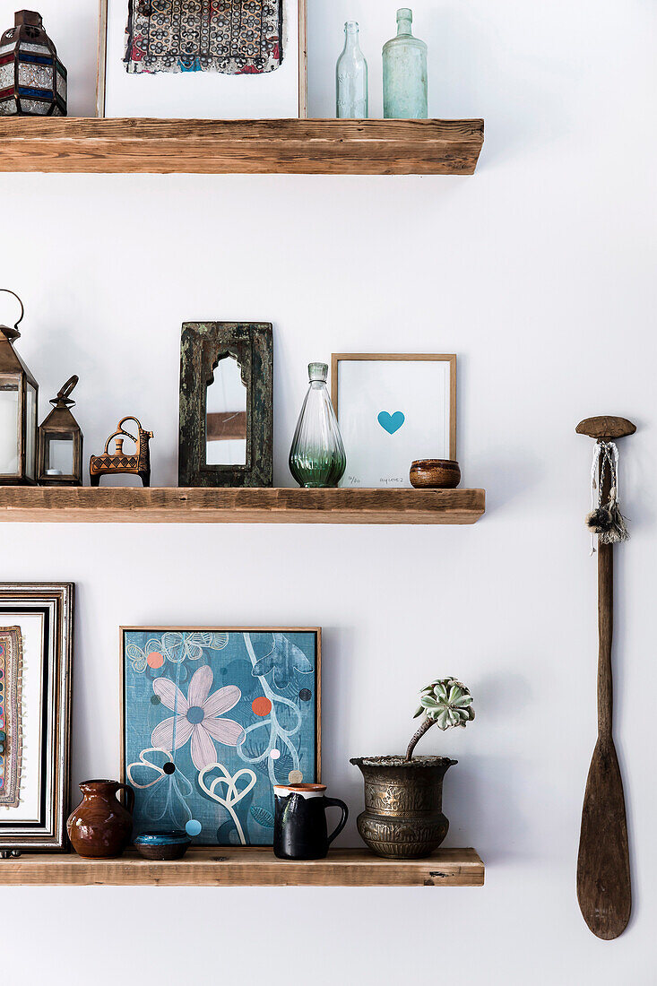 Paddle next to rustic shelves with ethnic decorations