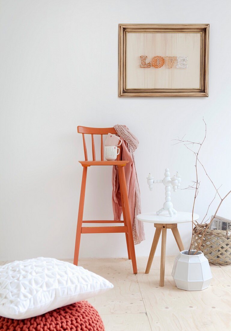 Framed string art, side table and orange retro bar stool