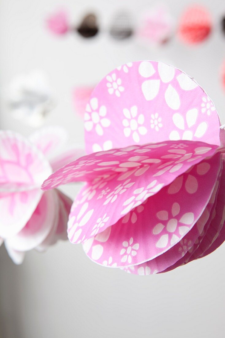 Pink paper garland with white floral pattern