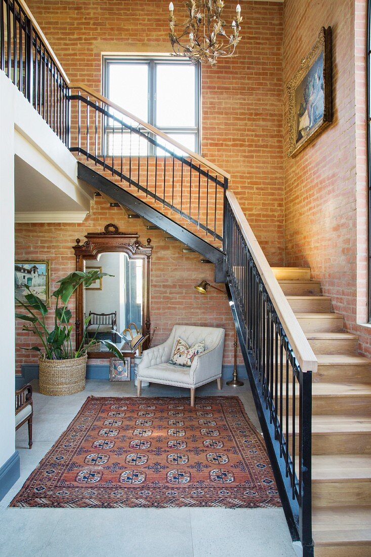 Staircase and brick walls in inviting foyer