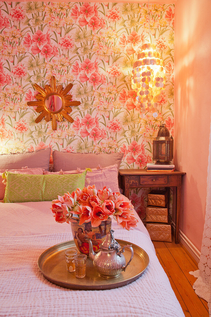 Flowers and teapot on tray in romantic bedroom