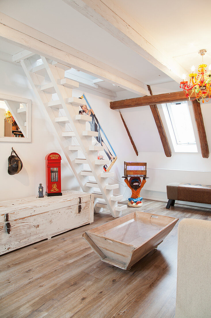Wooden furniture and white staircase in attic living room